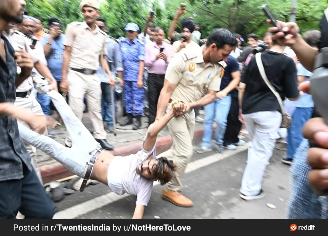 Police member dragging a protester